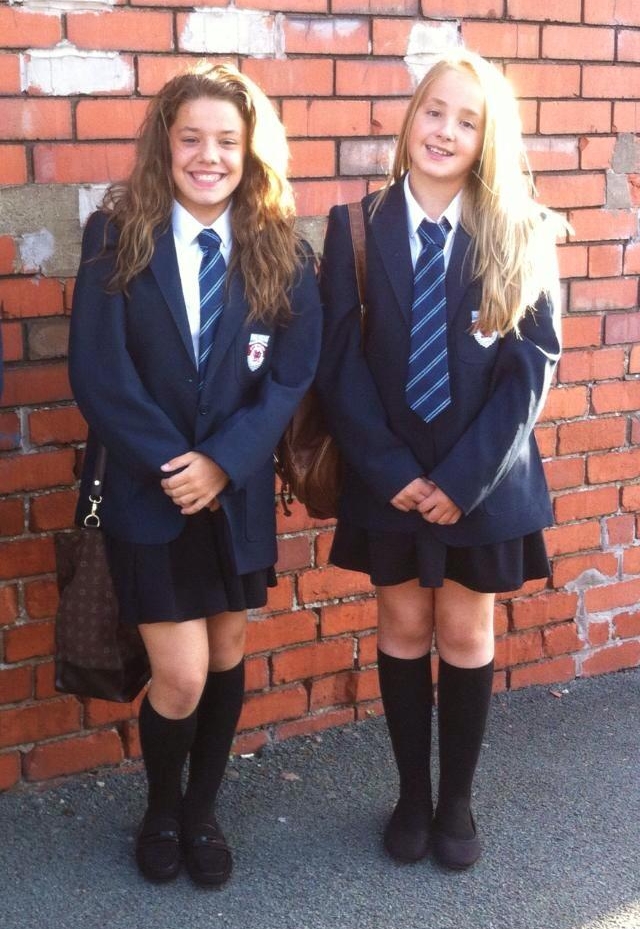 Two Schoolgirls wearing Black Long Socks and Blue Pleated Miniskirts